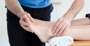 Close-up of a Caucasian physical therapist giving a foot massage